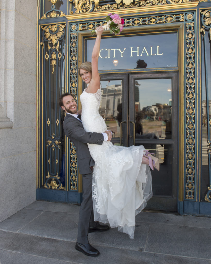 Bride Cheering in front of the city hall sign