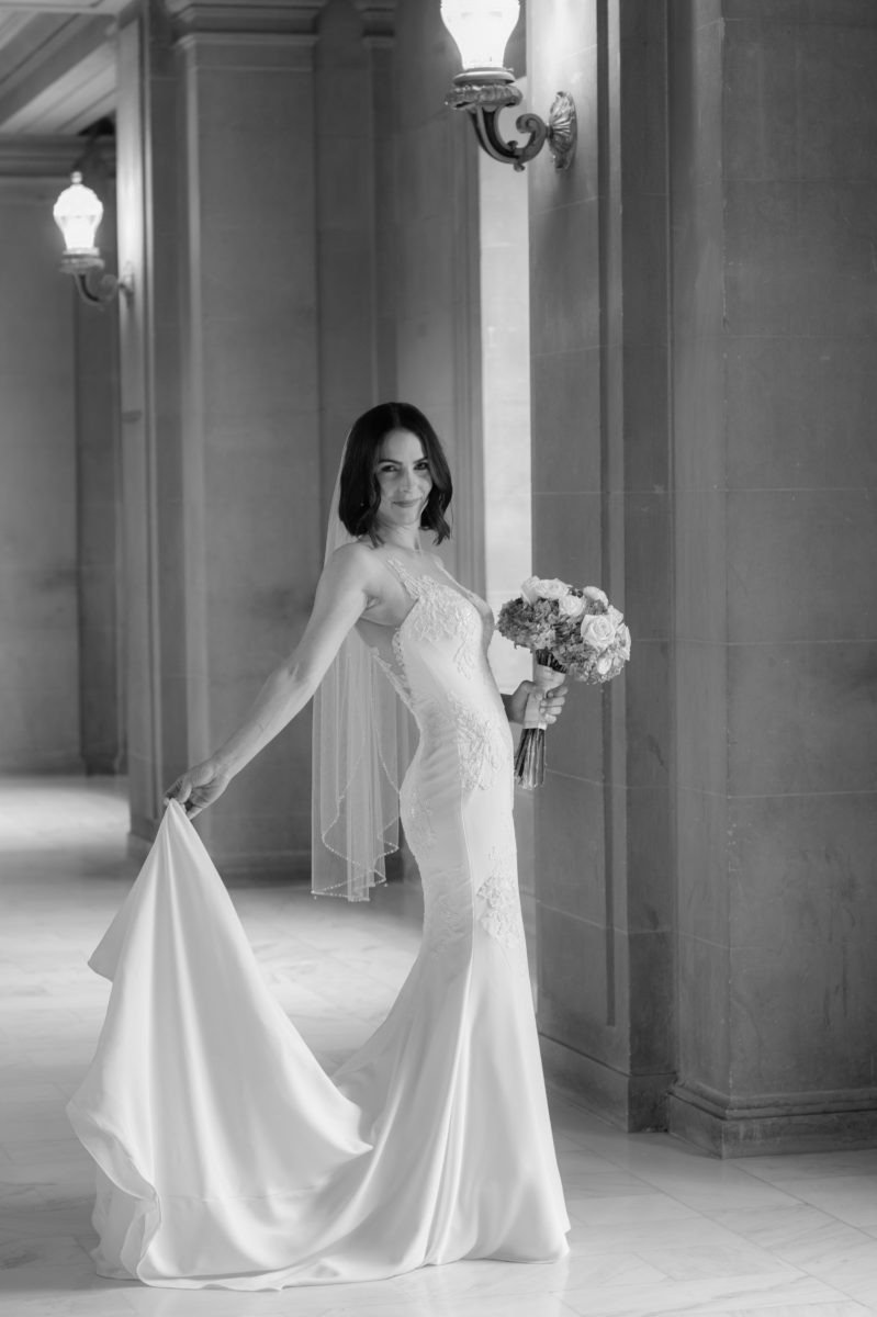 June City Hall bride holding her train