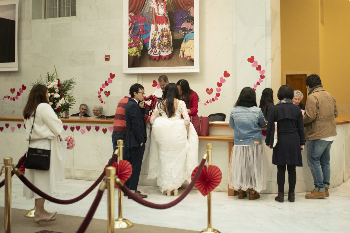 Multiple brides waiting to get married at SF City Hall