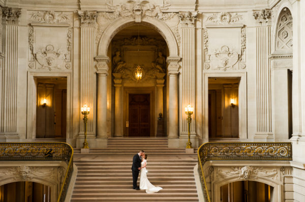 Top of the Grand Staircase SF City Hall bride and groom