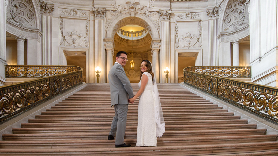 Bride and Groom looking back from the Grand Staircase at San Francisco city hall