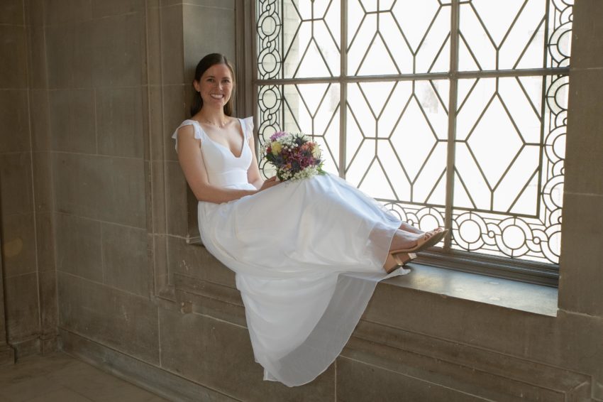 Pretty bride sitting in Window at San Francisco city hall