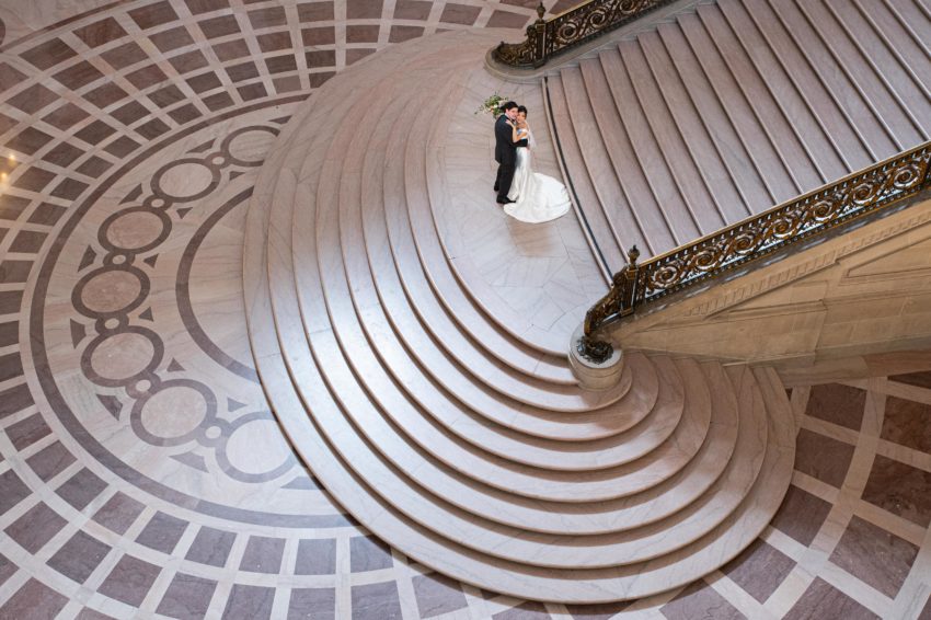 Top View of Grand Staircase at San Francisco city hall with newlyweds pictured