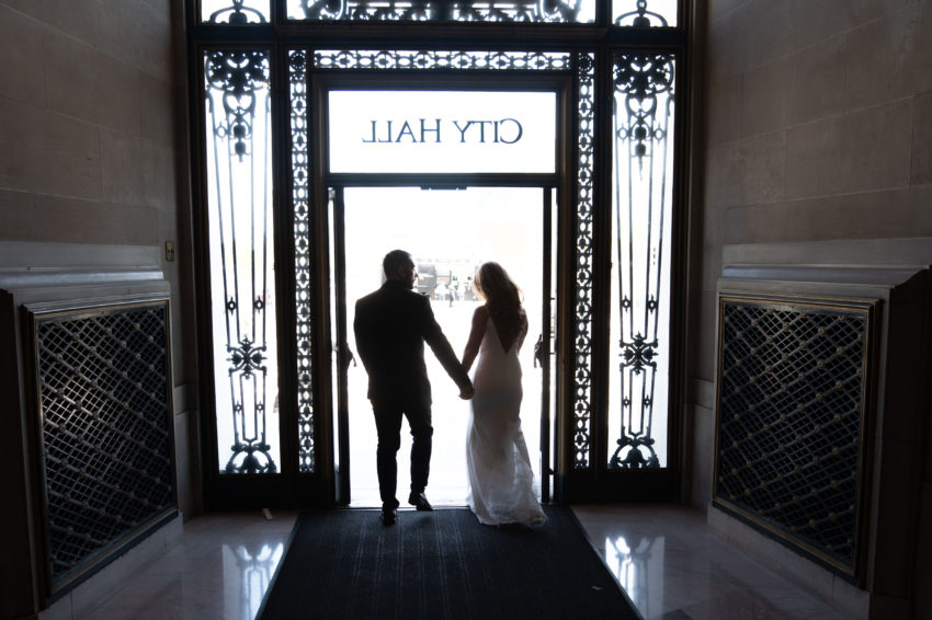 Newlyweds walking out of San Francisco city hall