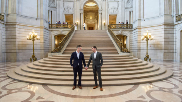 LGBTQ Couple holding hands on the Grand Staircase