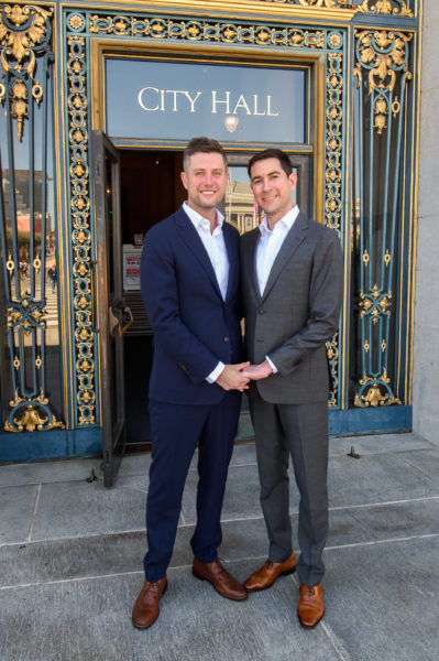 LGBTQ Couple holding hands in front of San Francisco city hall