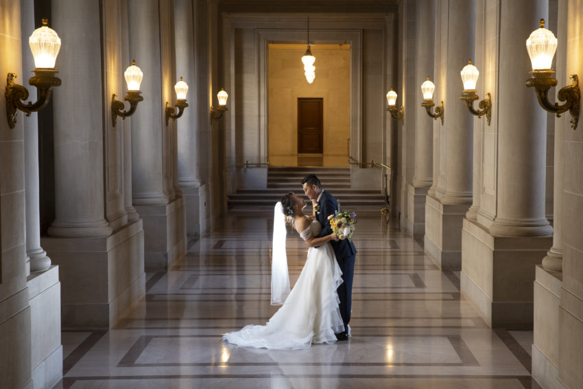 Hallway wedding photo at San Francisco city hall with flowers