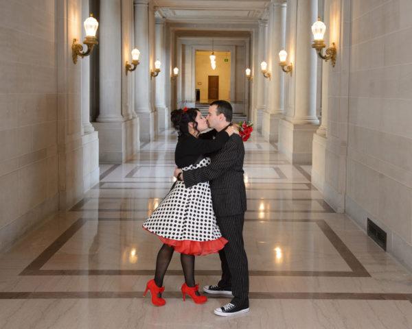 Fun newlyweds posing at SF City Hall