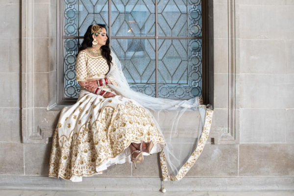 Indian bride sitting in the third floor window at SF City Hall