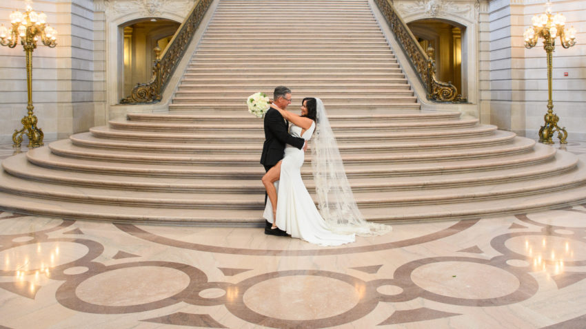 City Hall newlyweds on the grand staircase after their ceremony