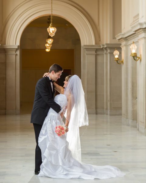 Bride and groom enjoying their wedding photography session at SF city hall
