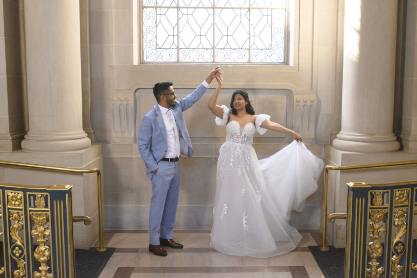 Bride and groom twirling at San Francisco city hall