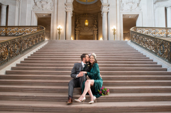 San Francisco City Hall newlyweds share a moment on the Grand Staircase