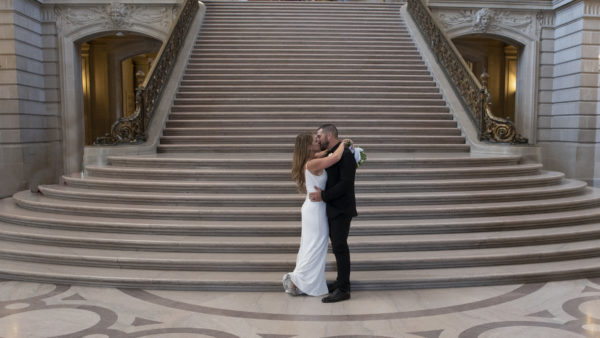 bride and groom kissing at San Francisco city hall
