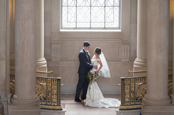 Great light at San Francisco city hall wedding - bride and groom.