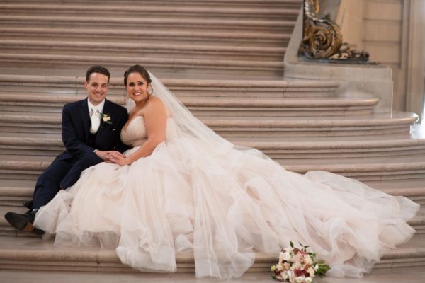 Bride and Groom smiling in the Staircase at city hall