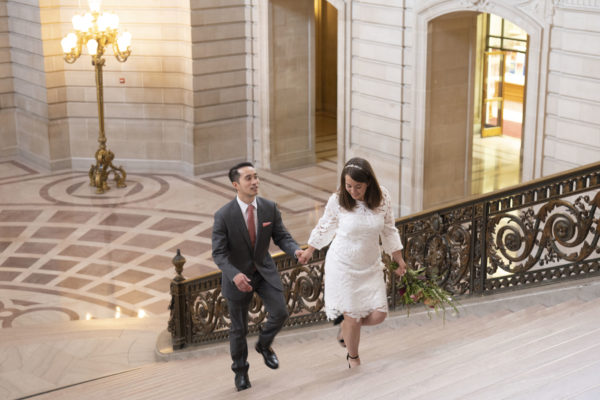 Newlyweds walking up the Grand Staircase