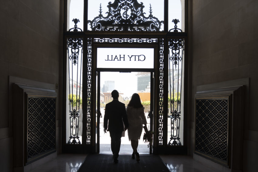 Newlyweds walking out of San Francisco city hall