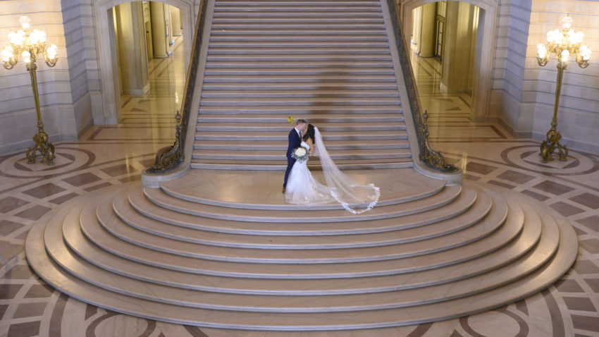 Grand Staircase at San Francisco city hall with bride and groom posing