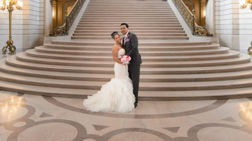 San Francisco city hall bride and groom posing for pictures