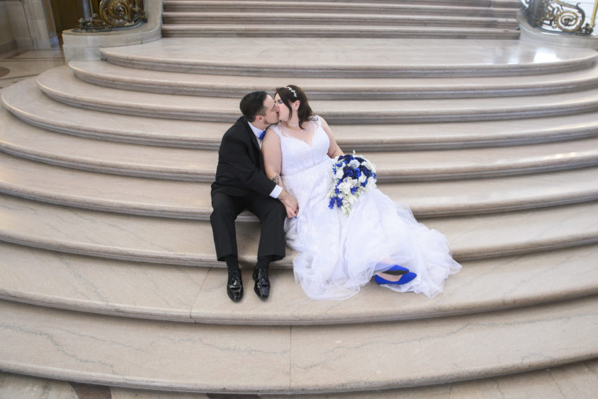 bride and groom Candid moment while relaxing on Grand Staircase at SF City Hall
