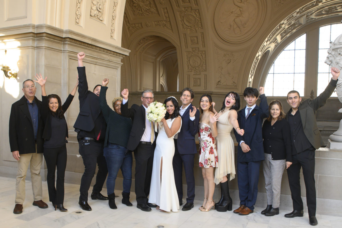 Fun wedding guests celebrate with the bride and groom at San Francisco city hall
