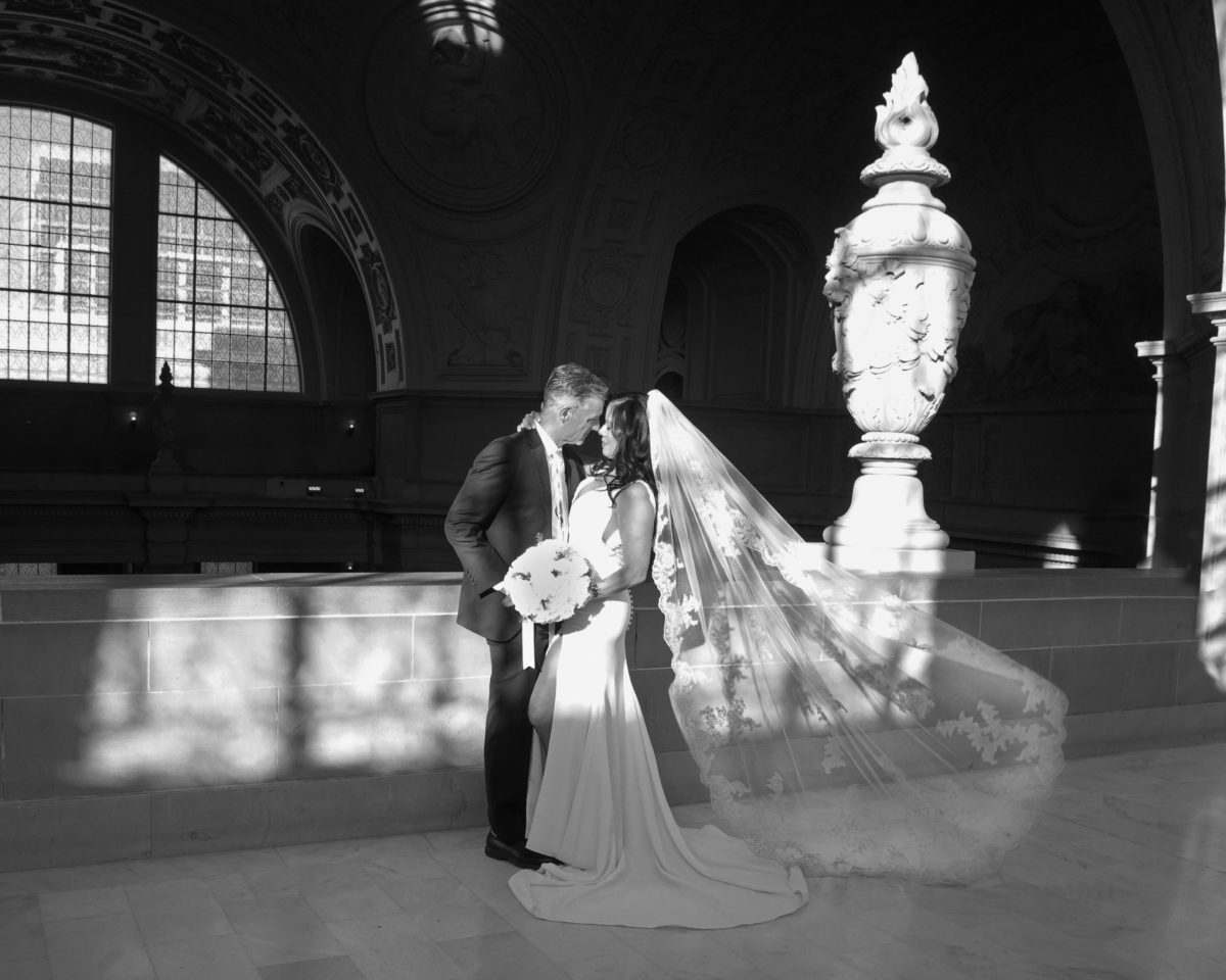 Lighting coming in from the windows, makes a wonderful pattern on the bride and groom.