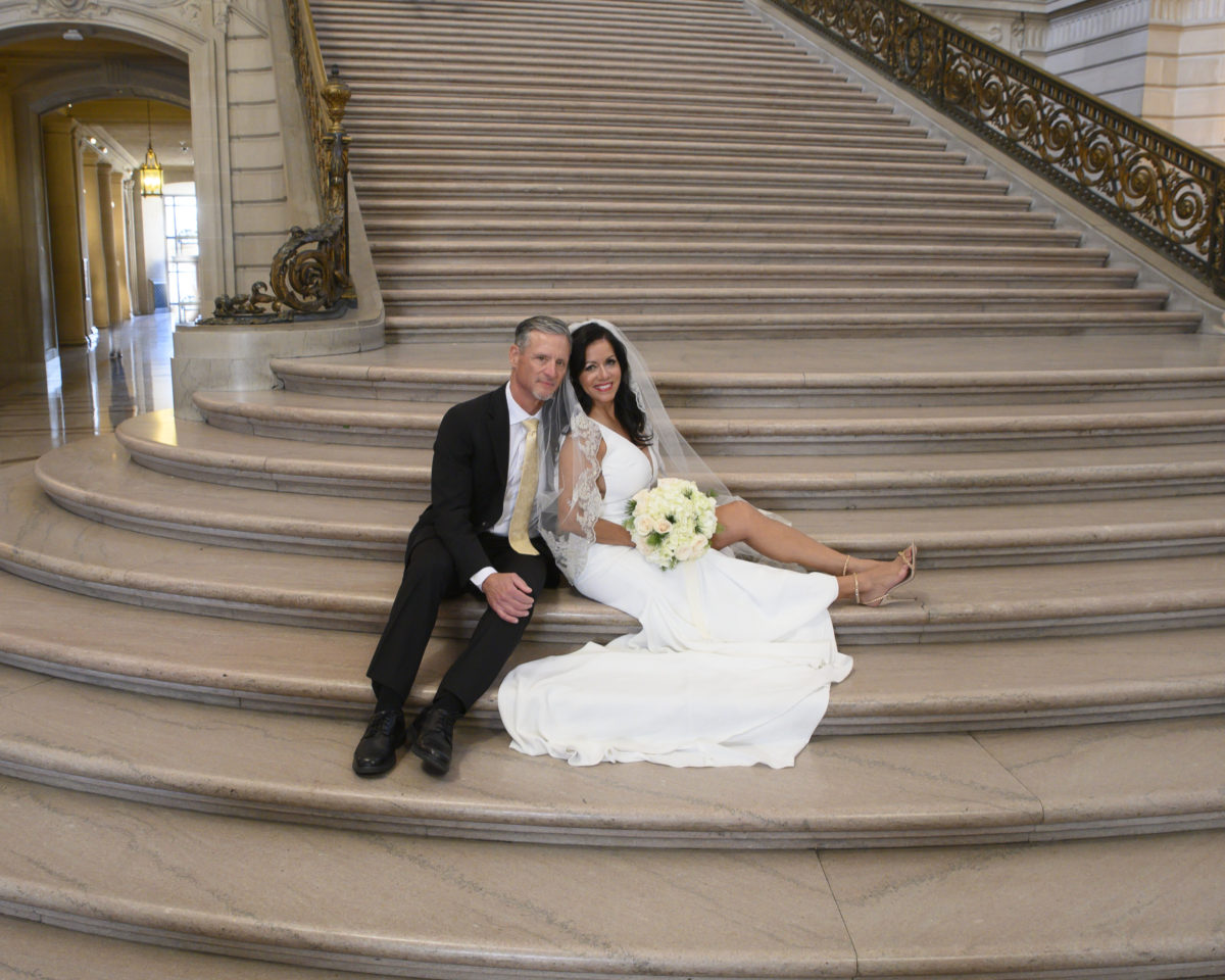 Bride and Groom sitting on the Grand Staircase