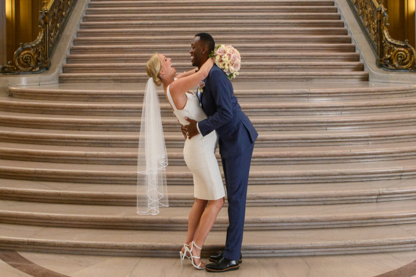 Maternity Bride and Groom pose on the city hall grand staircase