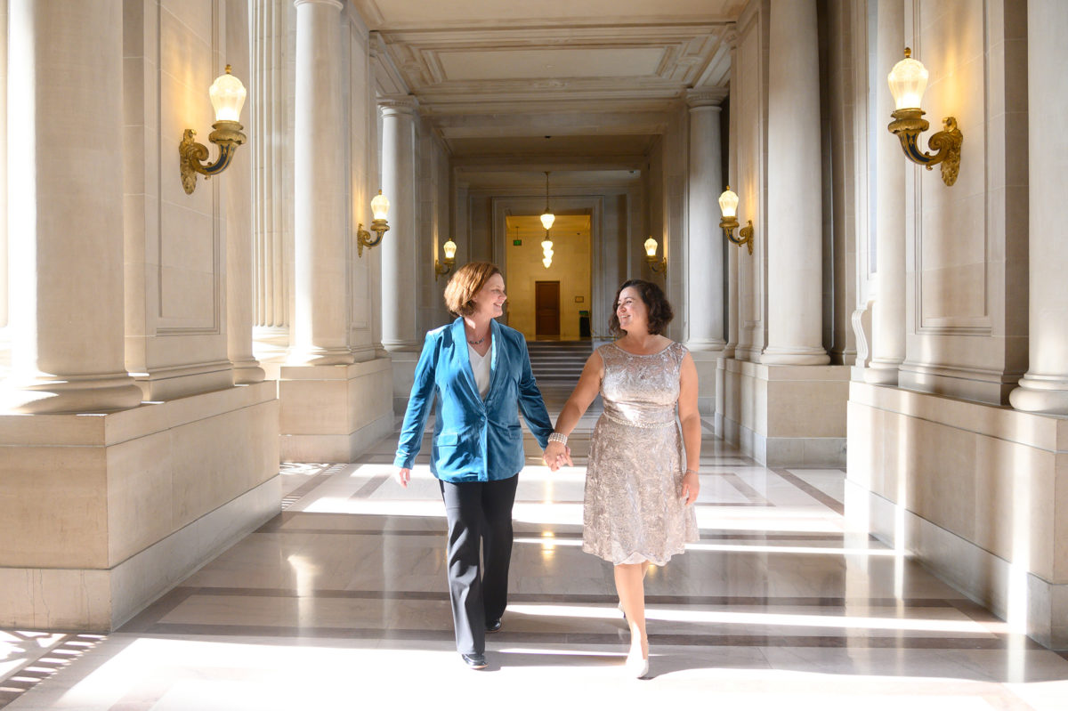 LGBTQ newlyweds walking through San Francisco city hall