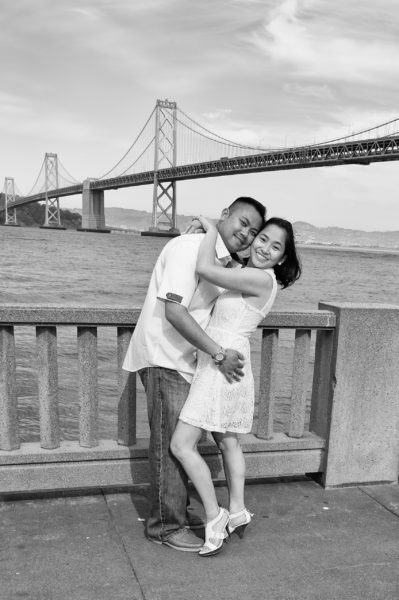 The San Francisco Bay Bridge with an engaged couple.