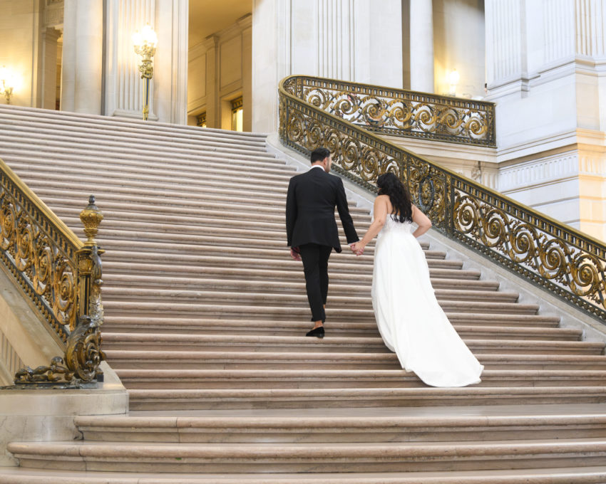 Bride and Groom walking up the Grand Staircase at San Francisco city hall