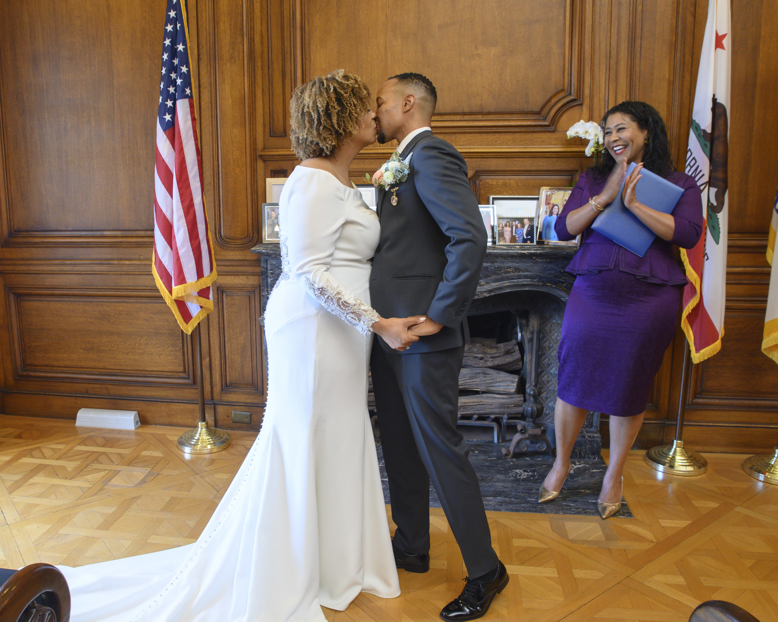 City Hall Bride and Groom kissing at ceremony officiated by London Breed.
