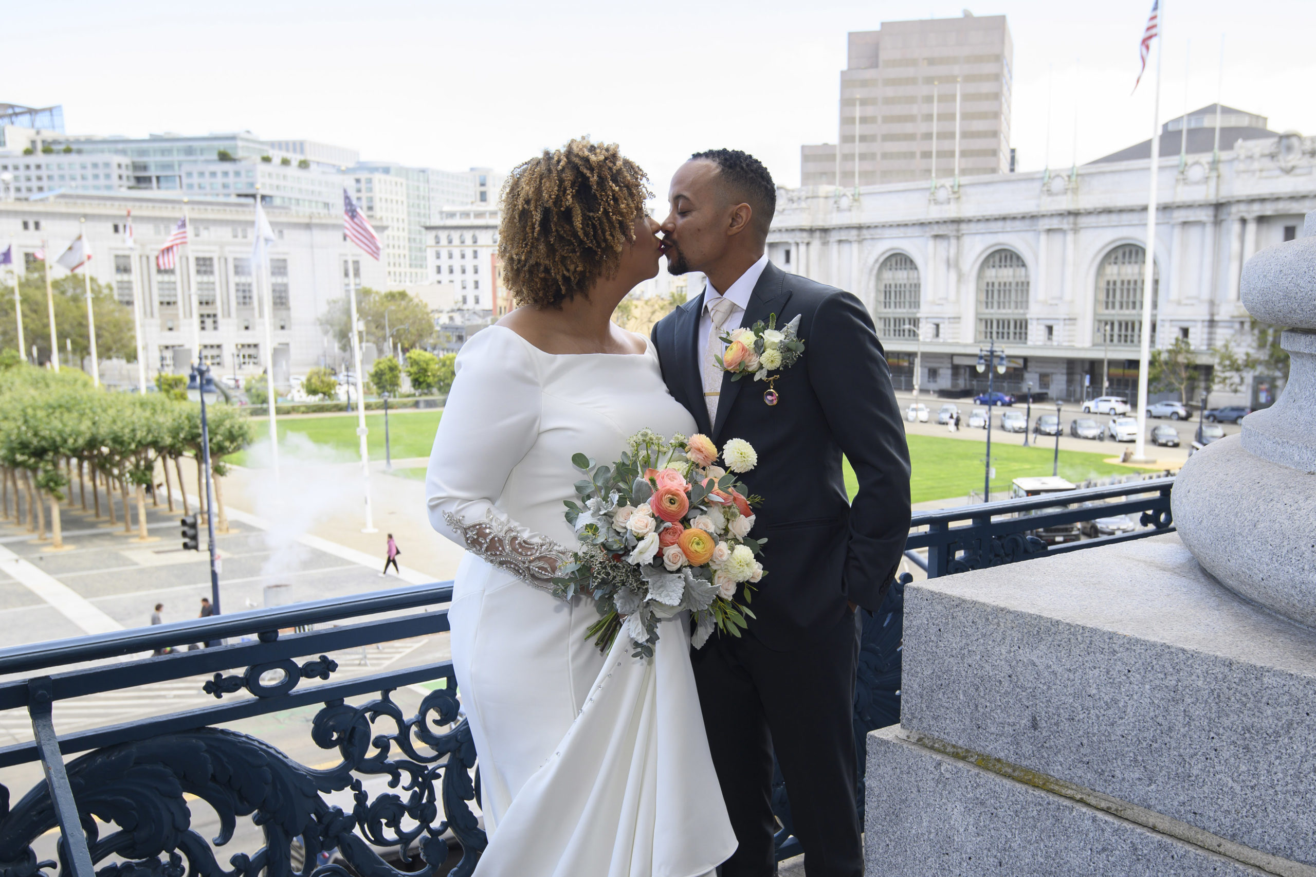 City Hall Bride and Groom pose for a picture on the Mayor's Balcony outside