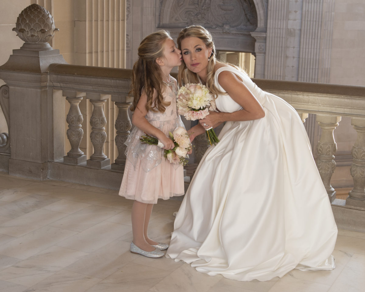 Flower Girl kissing San Francisco City Hall Bride on the cheek