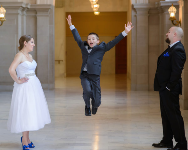 Child jumping at San Francisco city hall wedding photography session