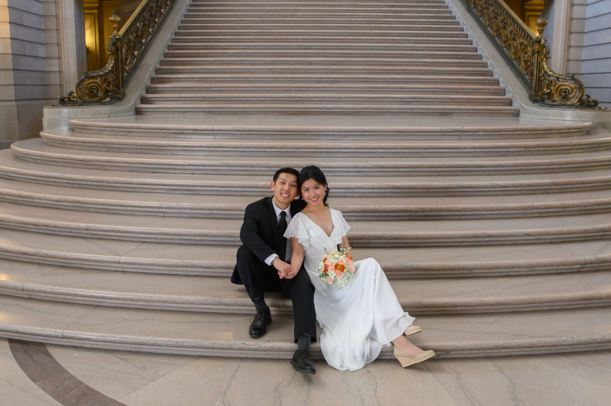 Bride and groom relaxing on the Grand Staircase after their Civil Ceremony at SF city hall