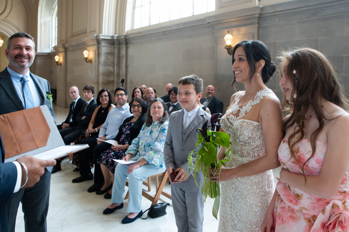 Young ring bearer helping at San Francisco city hall wedding ceremony