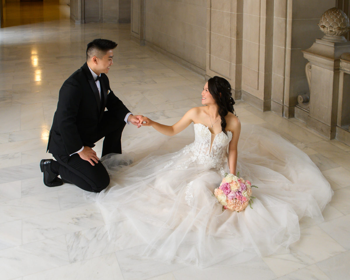 Romantic SF City Hall wedding image with bride and groom holding hands