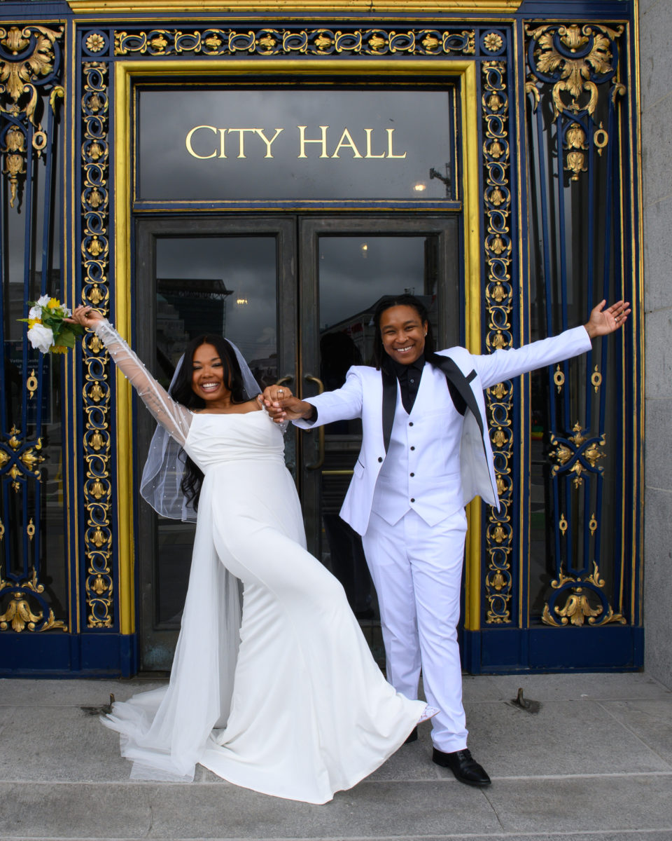 City Hall sign couple for this LGBTQ newlywed couple