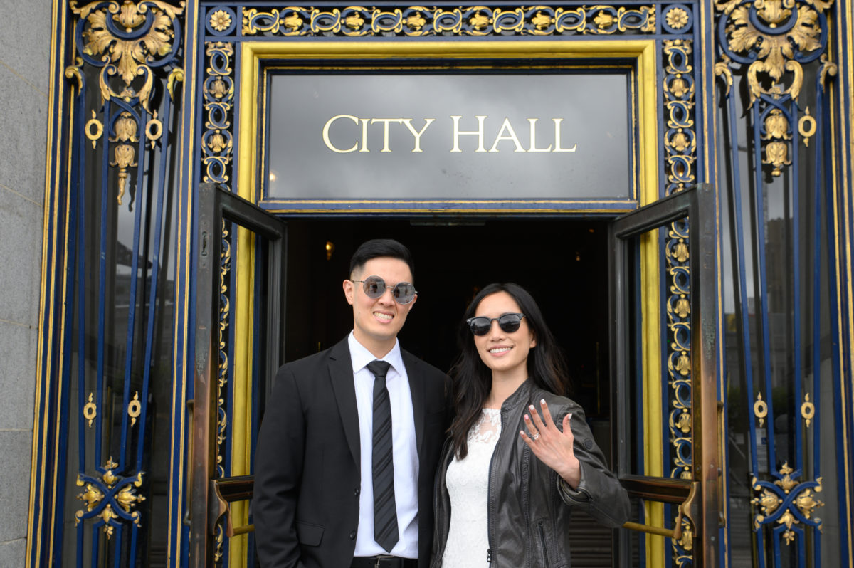SF City Hall newlyweds showing their ring as they leave the building