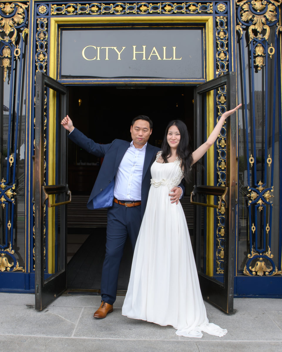 City Hall wedding picture with newlyweds celebrating