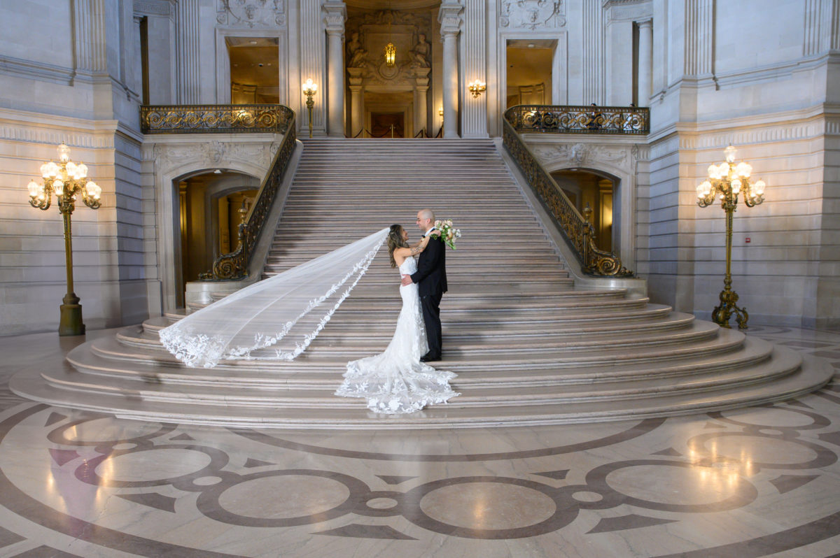 Flowing wedding veil on the grand staircase at San Francisco city hall.