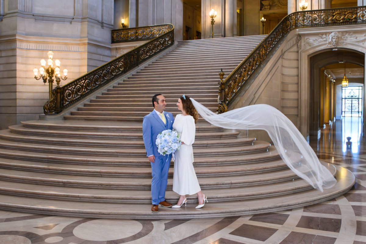 City Hall brides veil seems to be blowing in the wind on the Grand Staircase