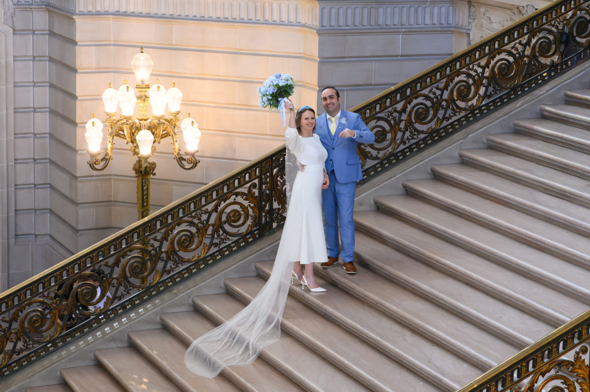 San Francisco city hall wedding picture of bride and groom celebrating after their marriage ceremony