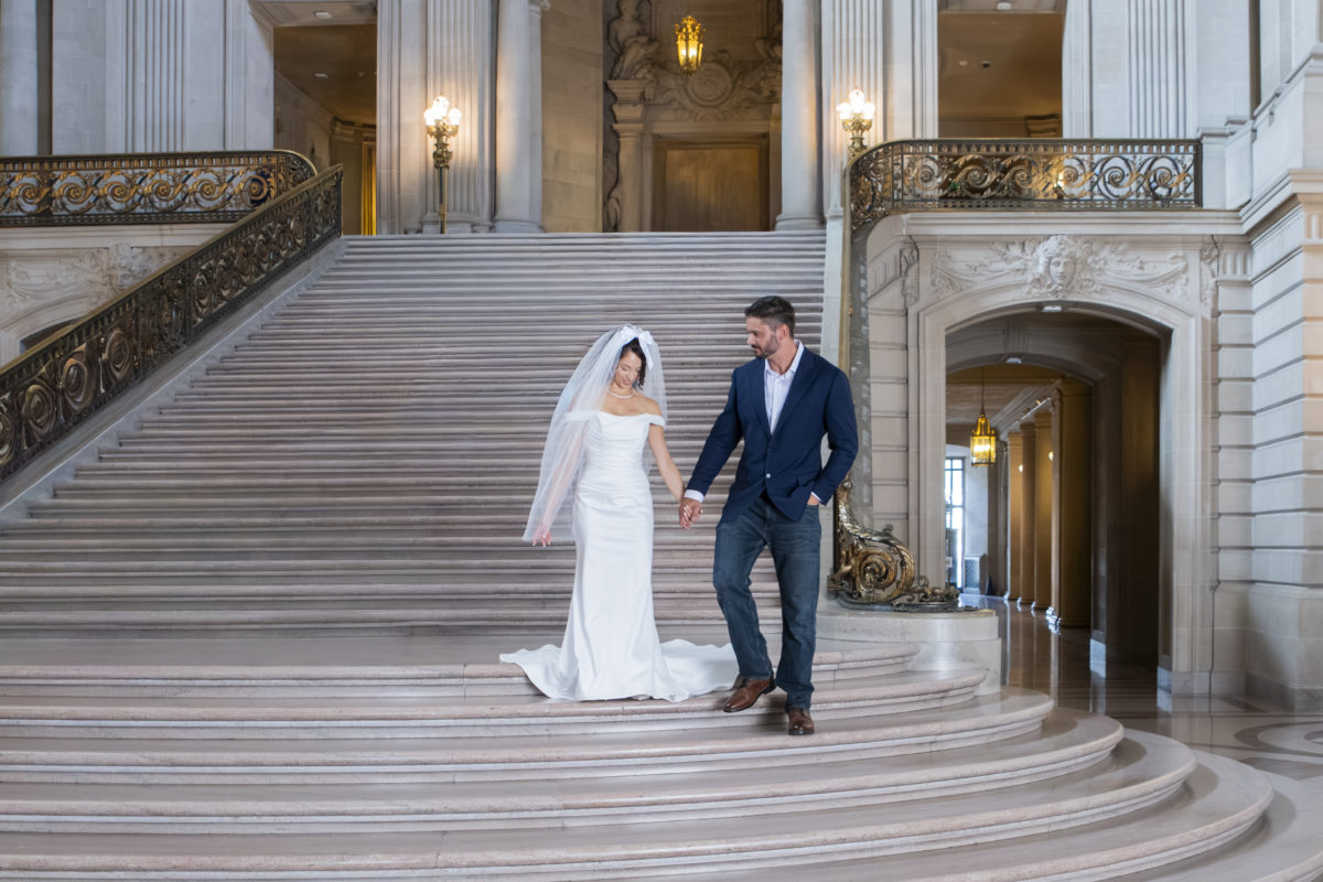 Walking down the stairs after the newlyweds completed their SF city hall wedding