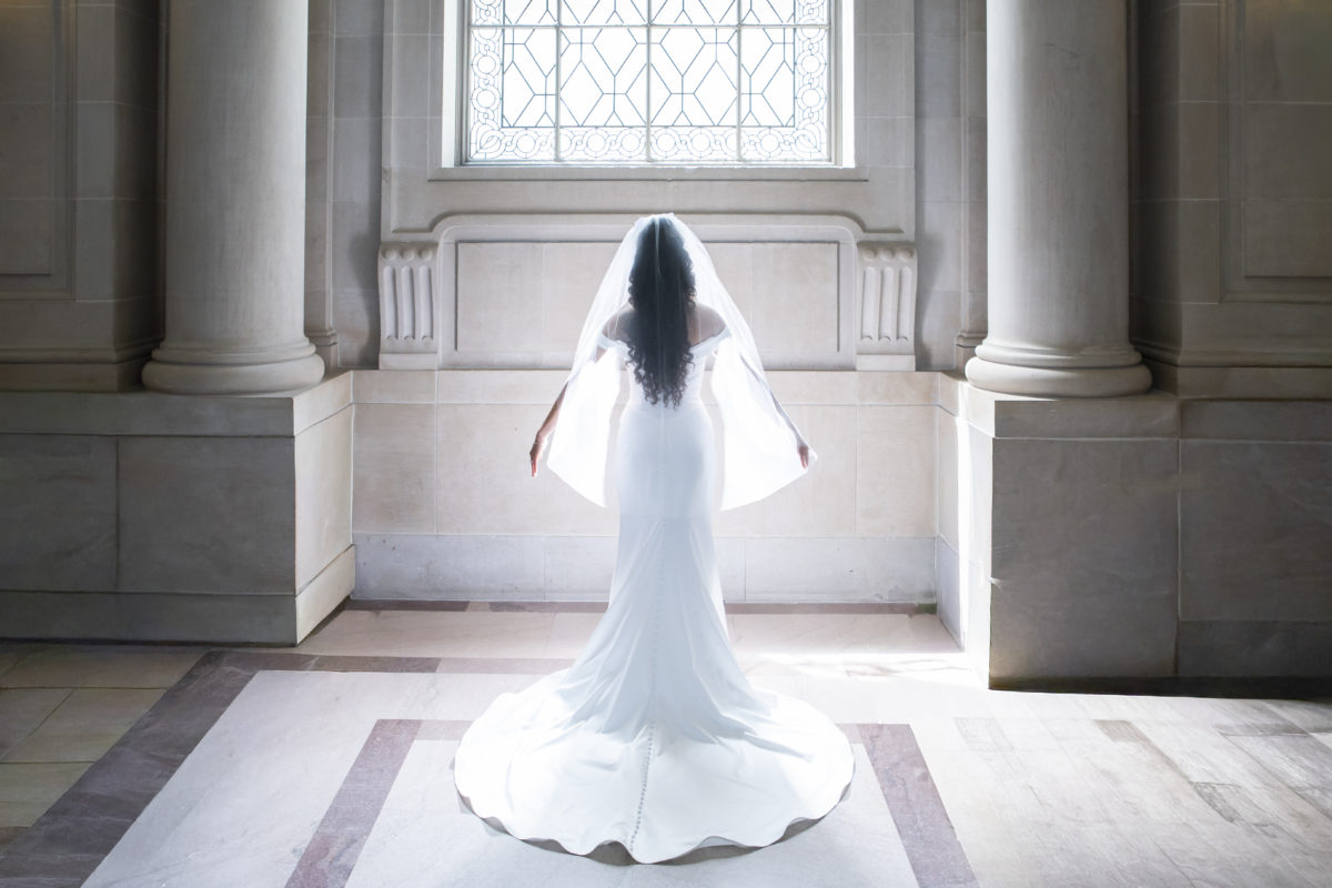Bride's veil glowing in an angelic fashion for SF city hall wedding photo