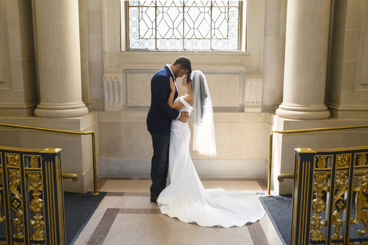 Dramatic lighting at San Francisco city hall marriage.