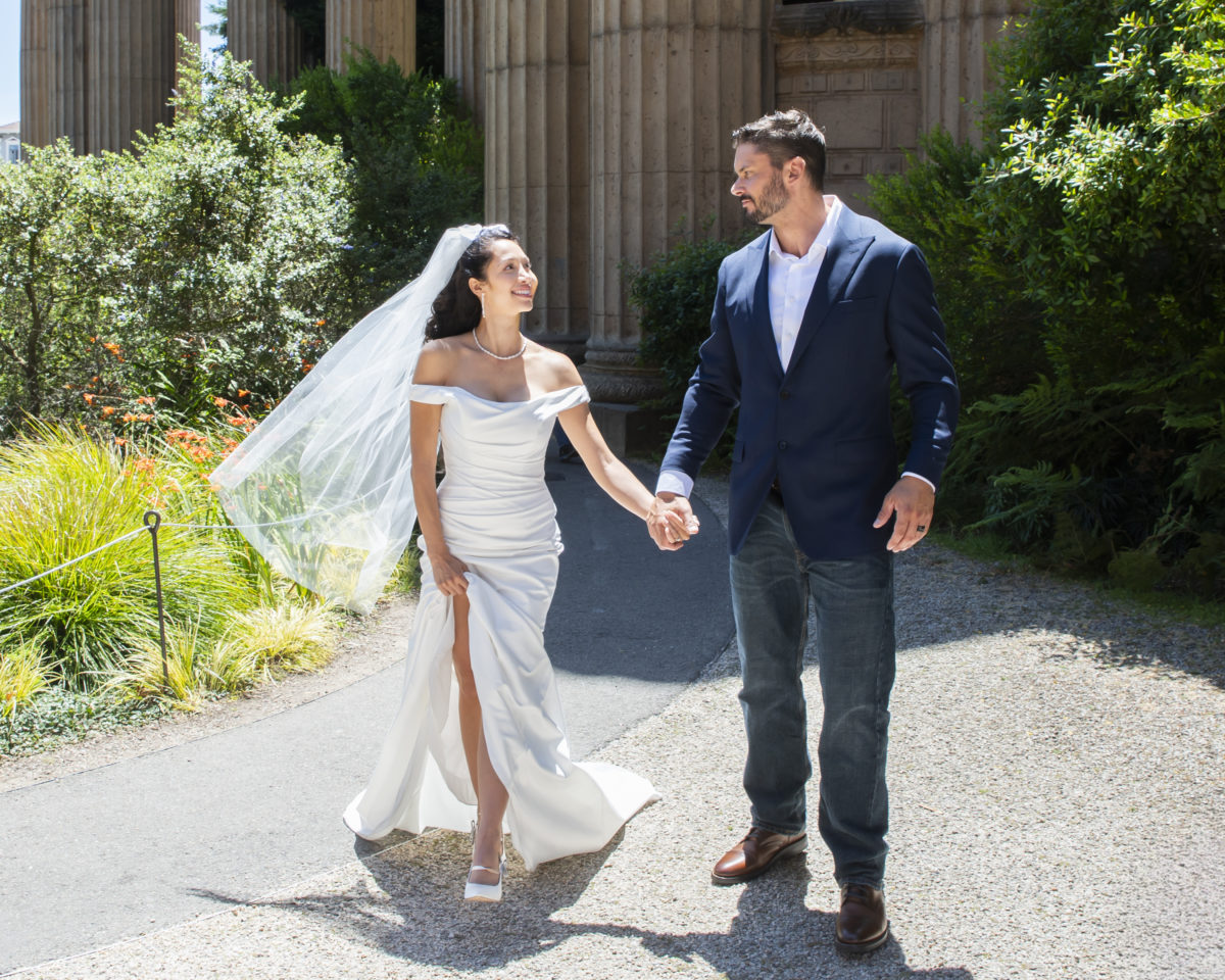 Bride and groom enjoying their walk at the Palace of Fine Arts