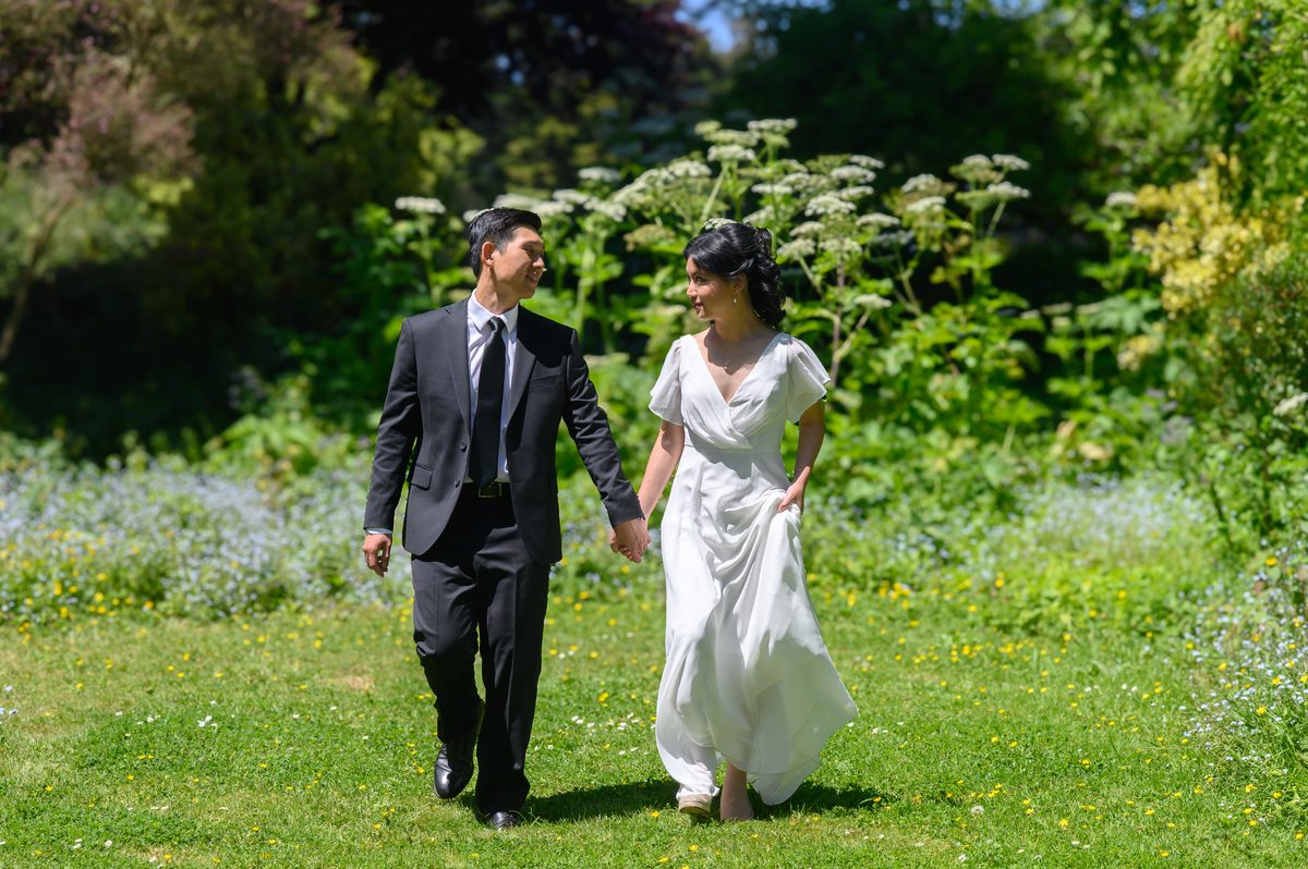 Newlyweds walking at Blue Heron Lake after their San Francisco city hall wedding.